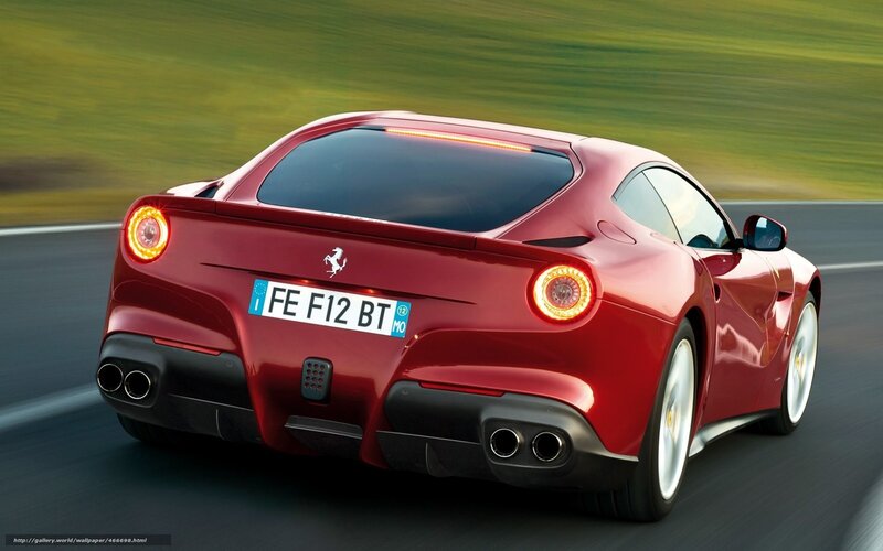 Red Ferrari F12 driving on road