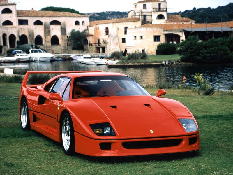 Red Ferrari F40 on a grassy shore