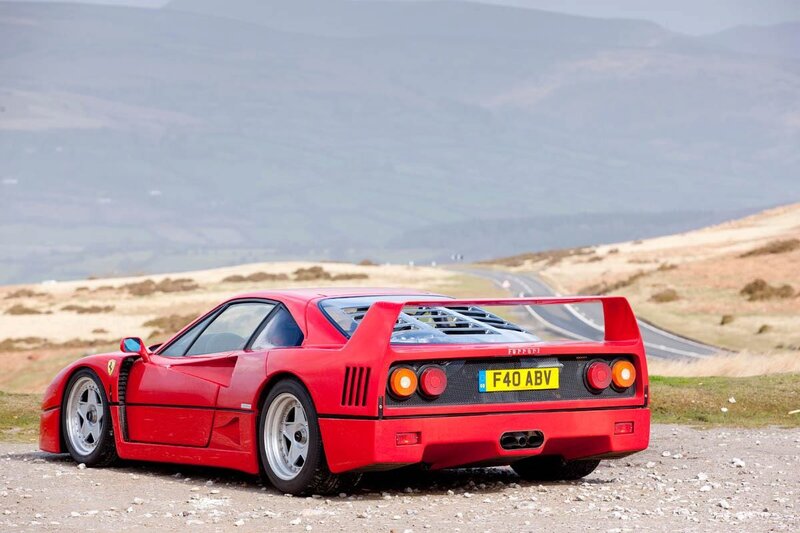 Red Ferrari F40 on a scenic road