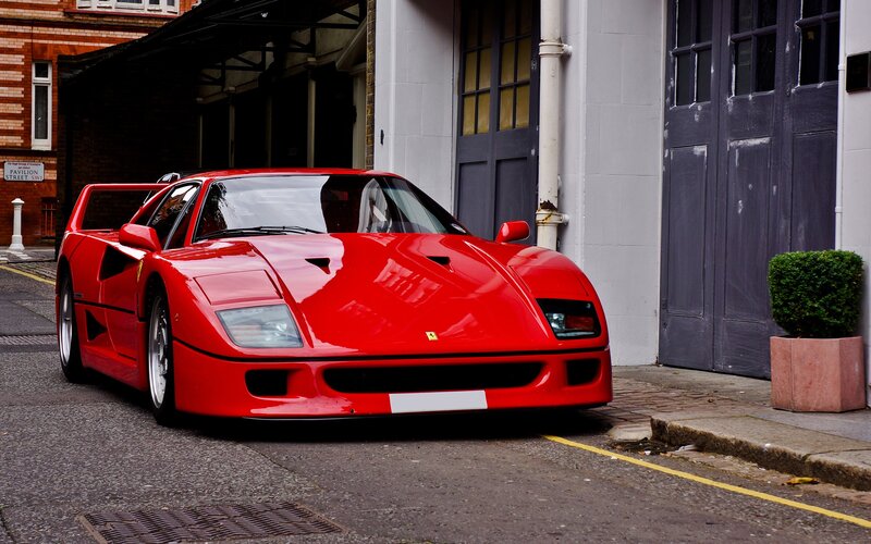 Red Ferrari F40 parked on street