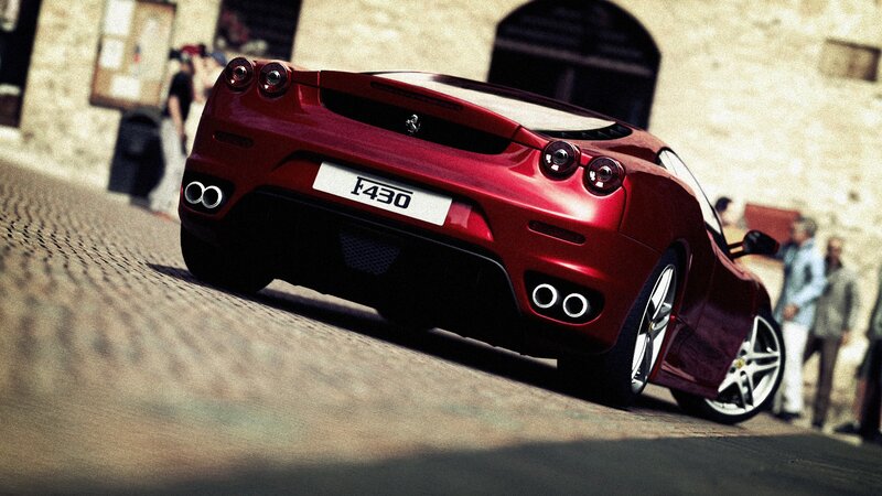 Red Ferrari F430 on cobblestone street