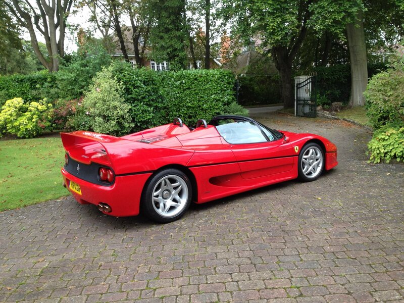 Red Ferrari F50 parked on driveway