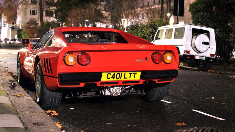Red Ferrari GTO parked at night