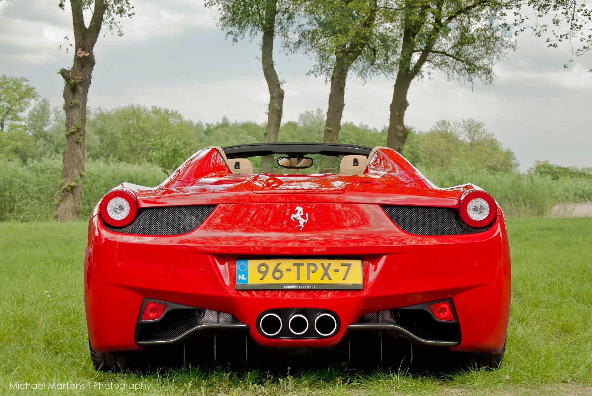 Red Ferrari in a field
