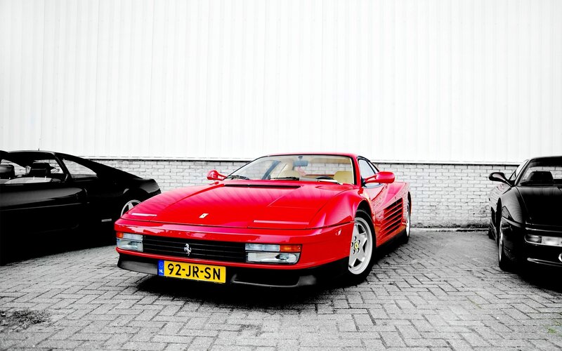 Red Ferrari in a parking lot