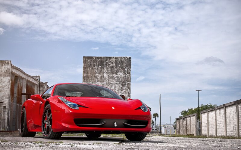 Red Ferrari in an industrial lot