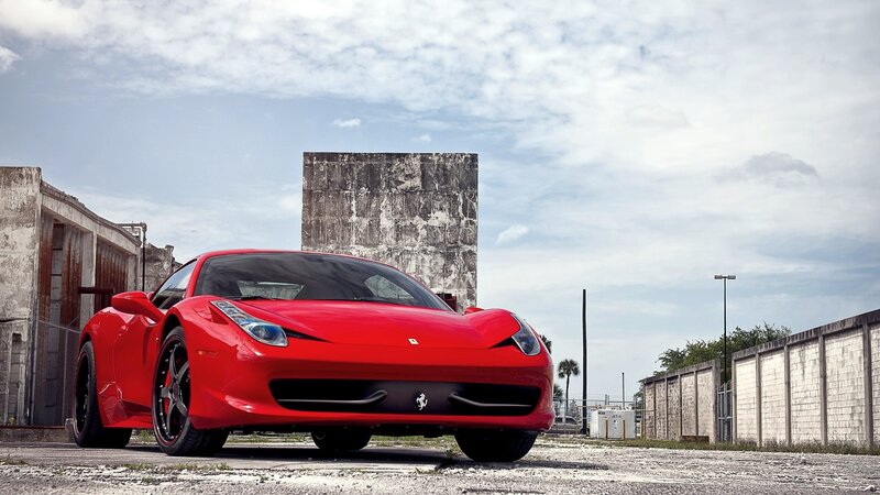 Red Ferrari in an industrial lot