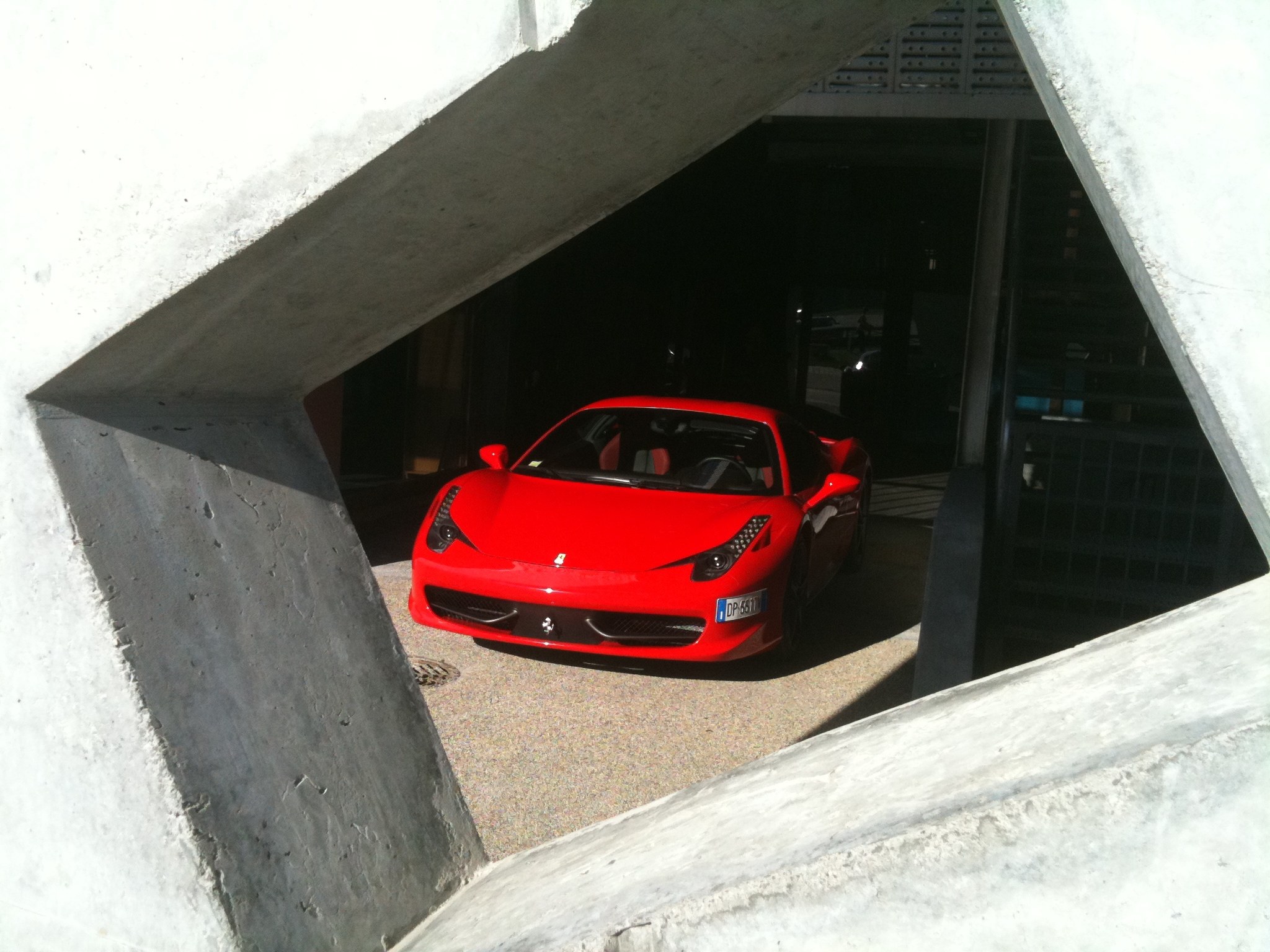 Red Ferrari in concrete structure