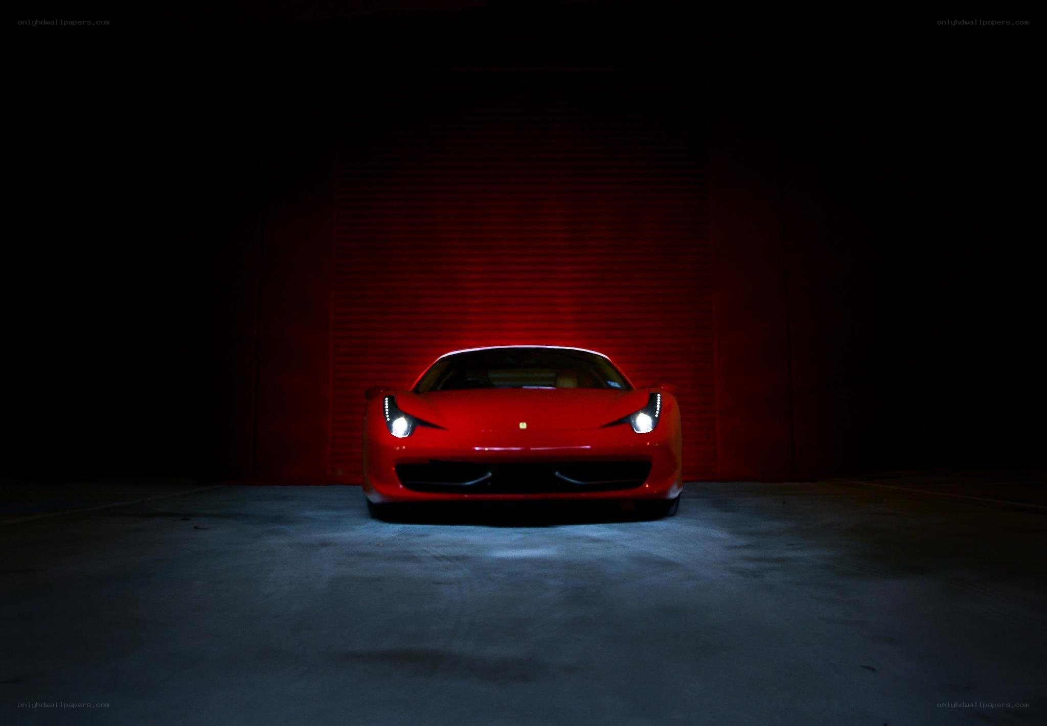 Red Ferrari in dark garage