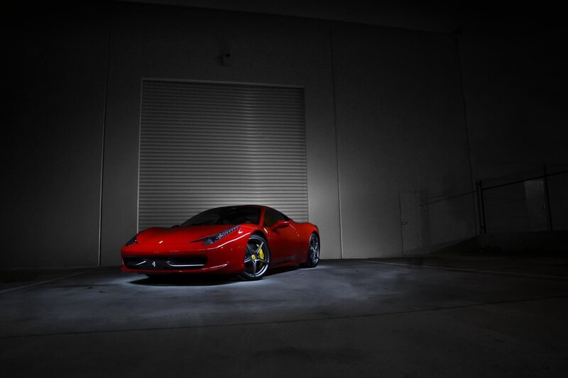 Red Ferrari in dark garage
