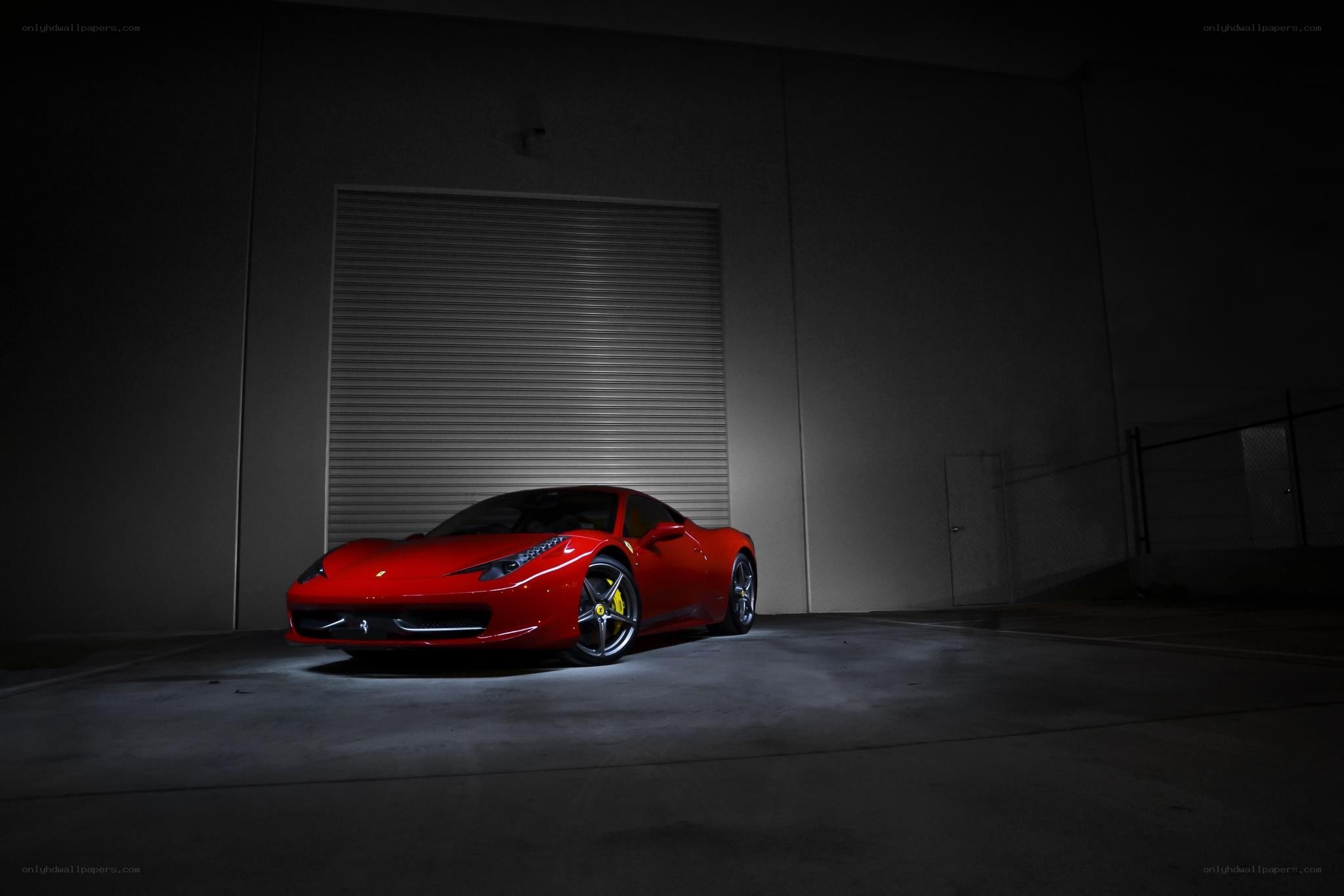 Red Ferrari in dark garage
