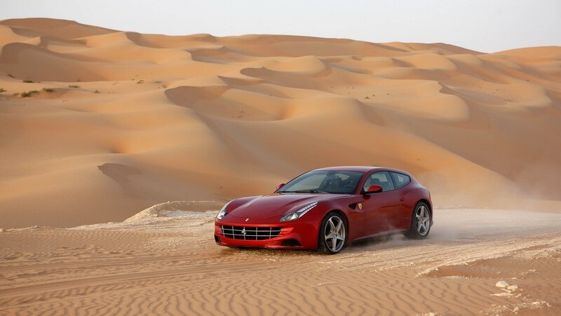 Red Ferrari in desert dunes