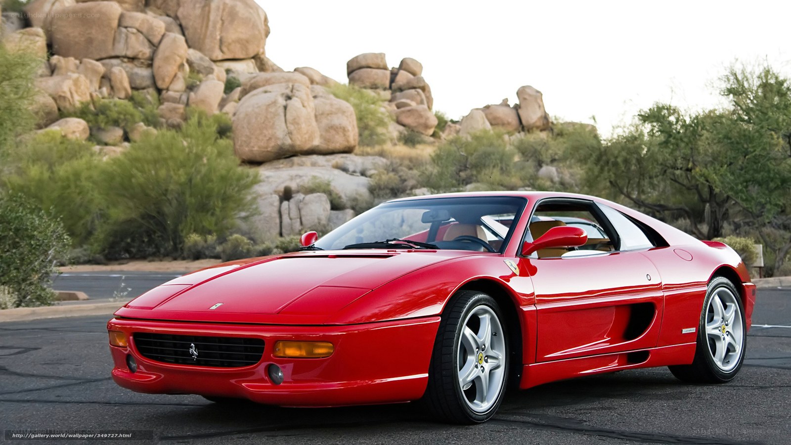 Red Ferrari in desert landscape