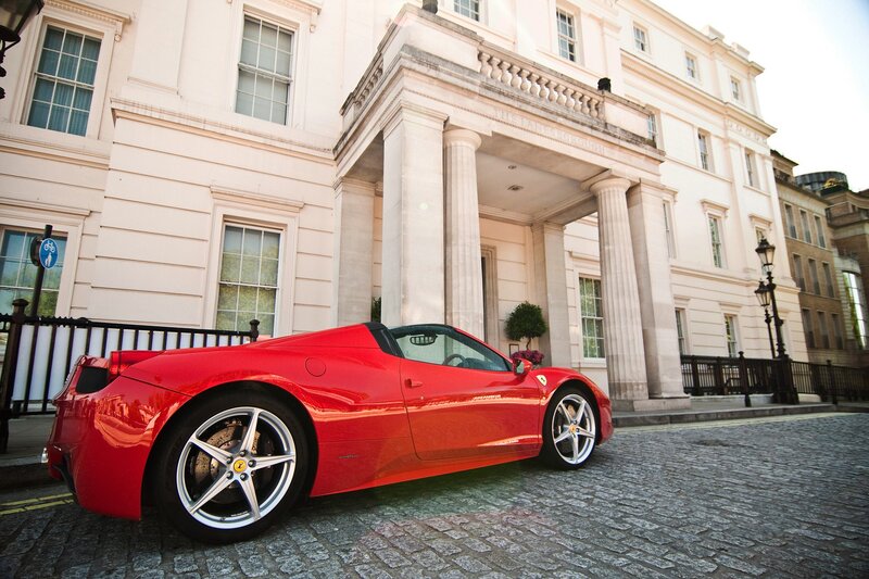 Red Ferrari in front of a building