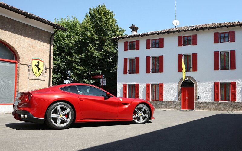 Red Ferrari in front of a building