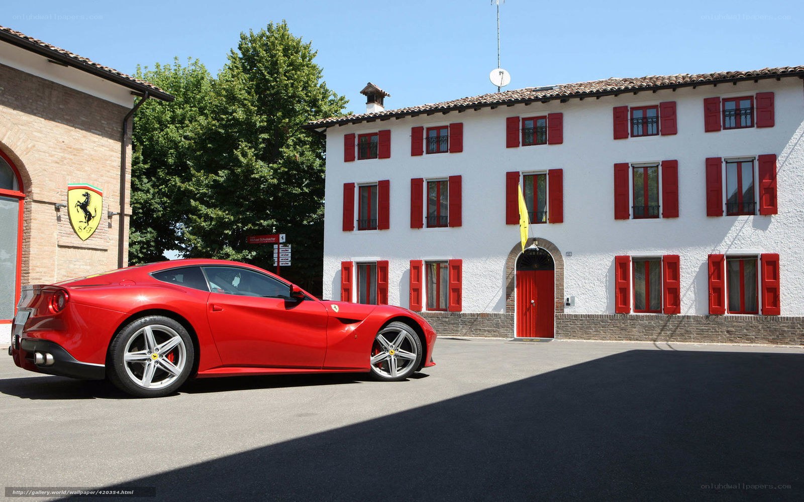 Red Ferrari in front of building