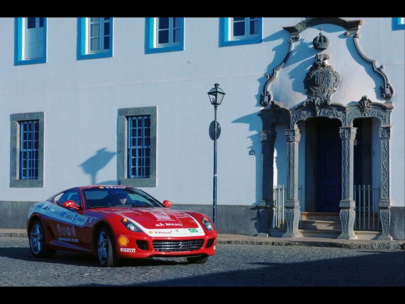 Red Ferrari in front of historic building