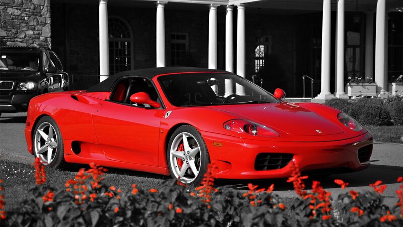 Red Ferrari in front of mansion