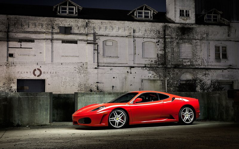 Red Ferrari in front of old building