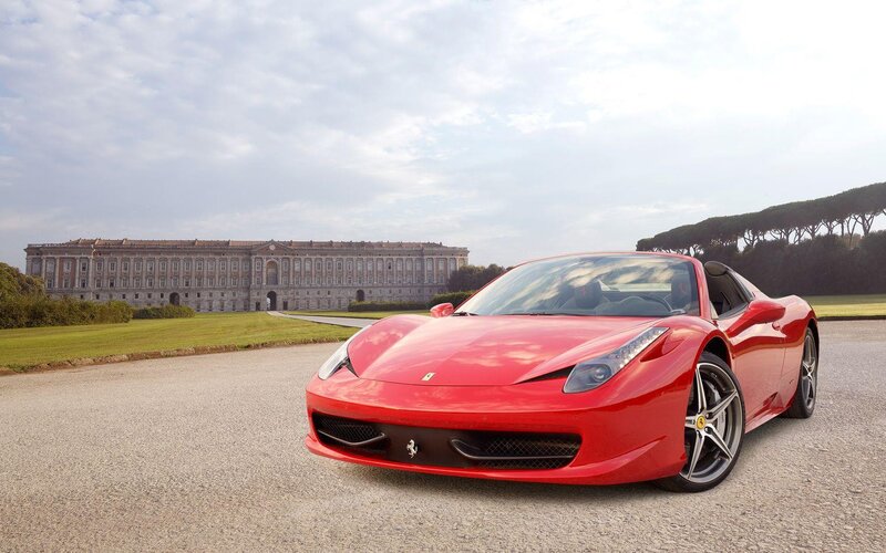 Red Ferrari in front of palace