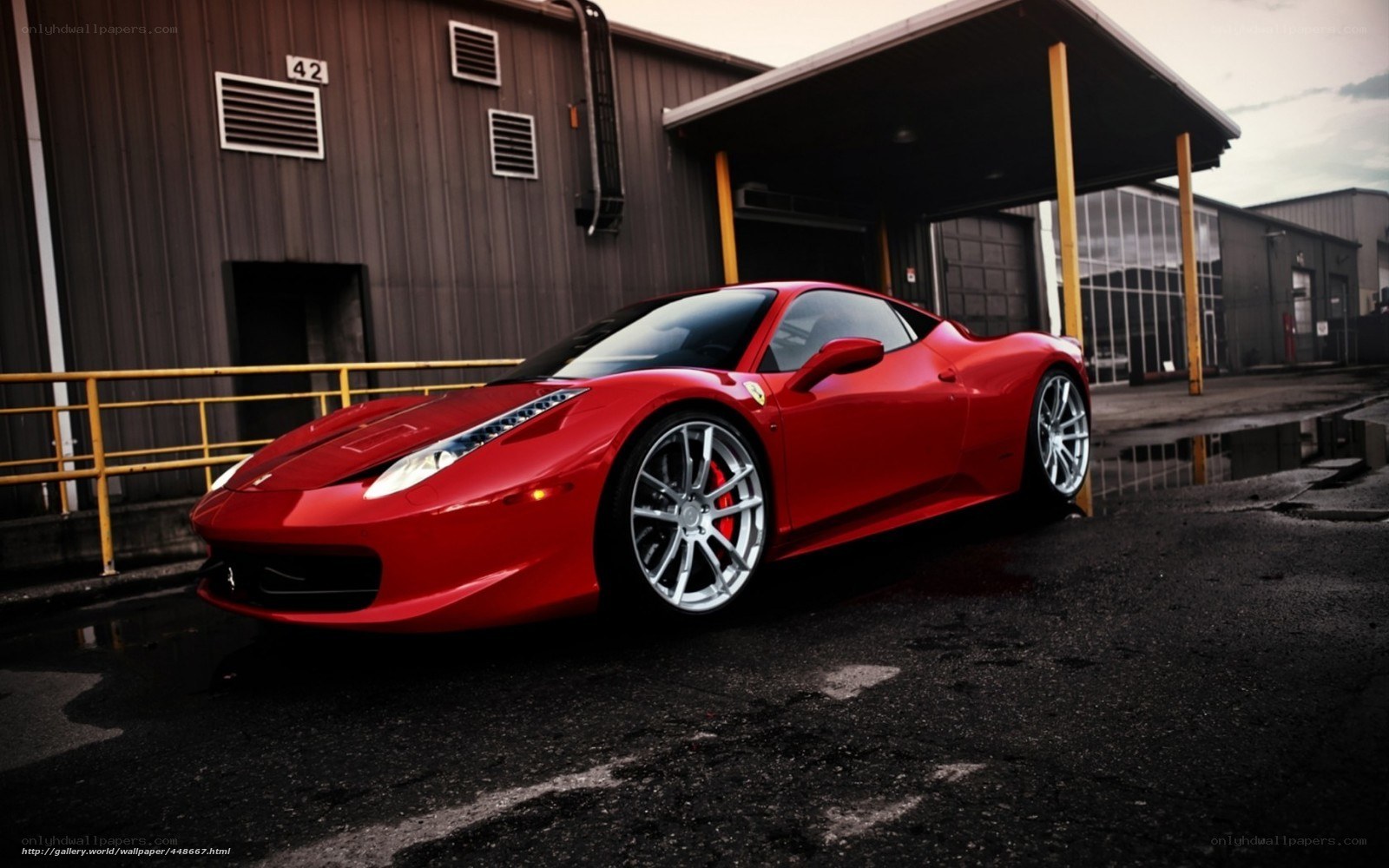 Red Ferrari in industrial lot