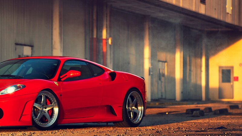 red ferrari in industrial setting