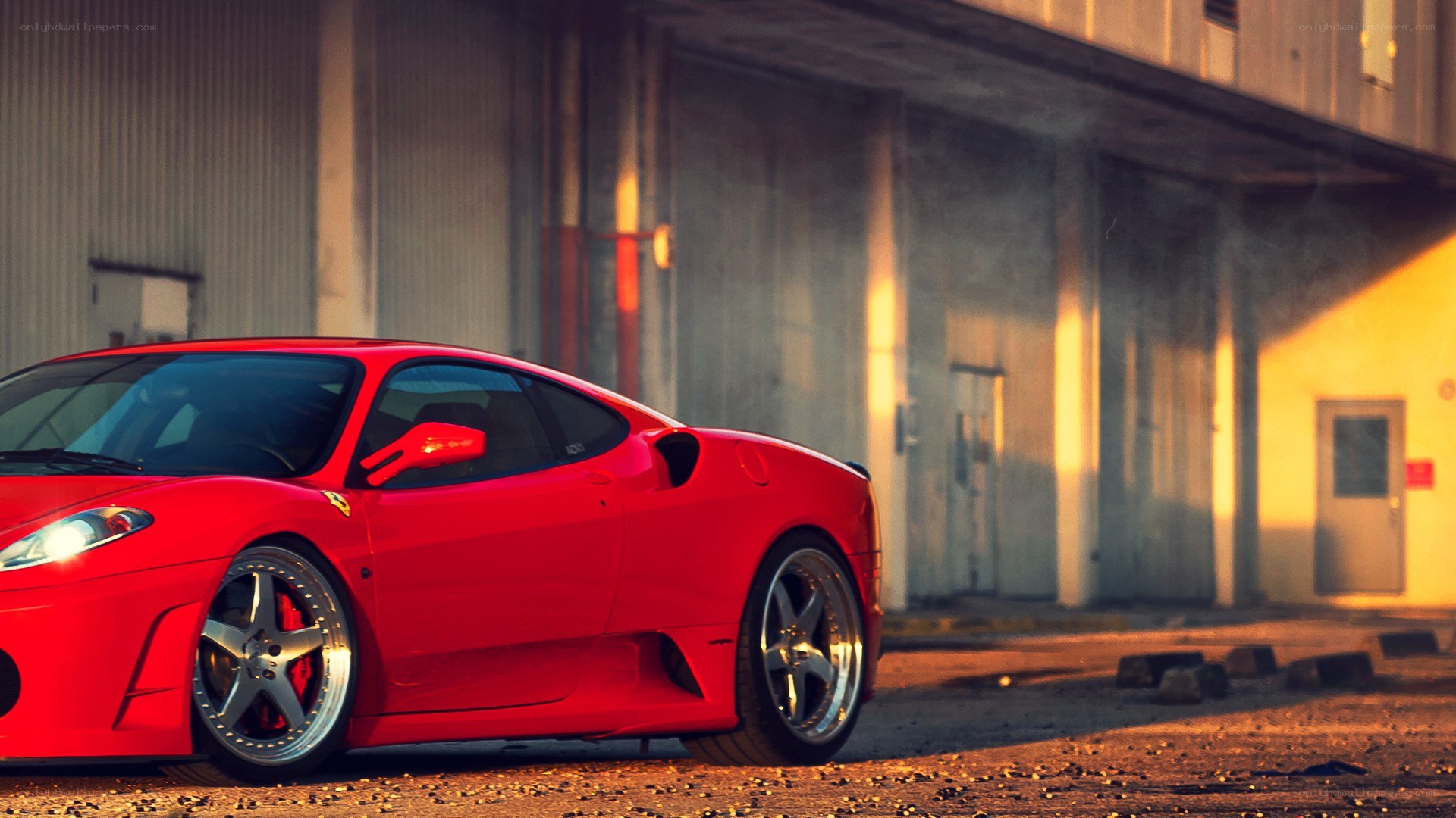 red ferrari in industrial setting