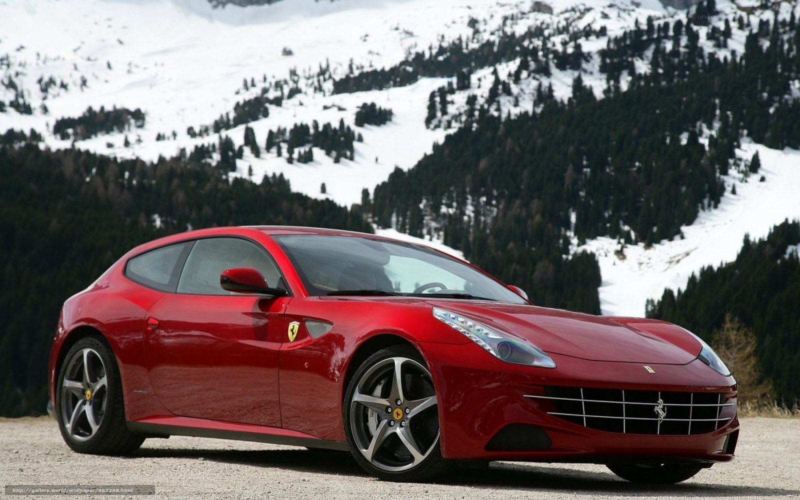 Red Ferrari in snowy mountains