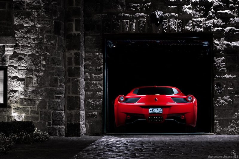 Red Ferrari in stone garage