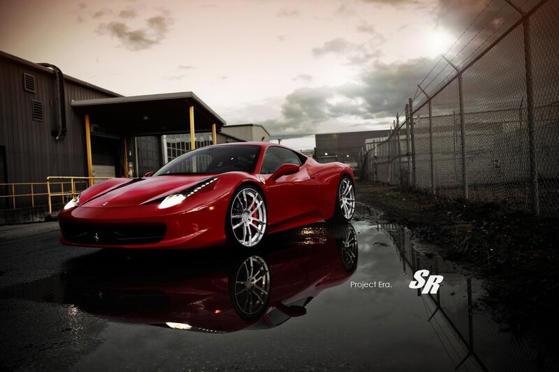 Red Ferrari in wet parking lot