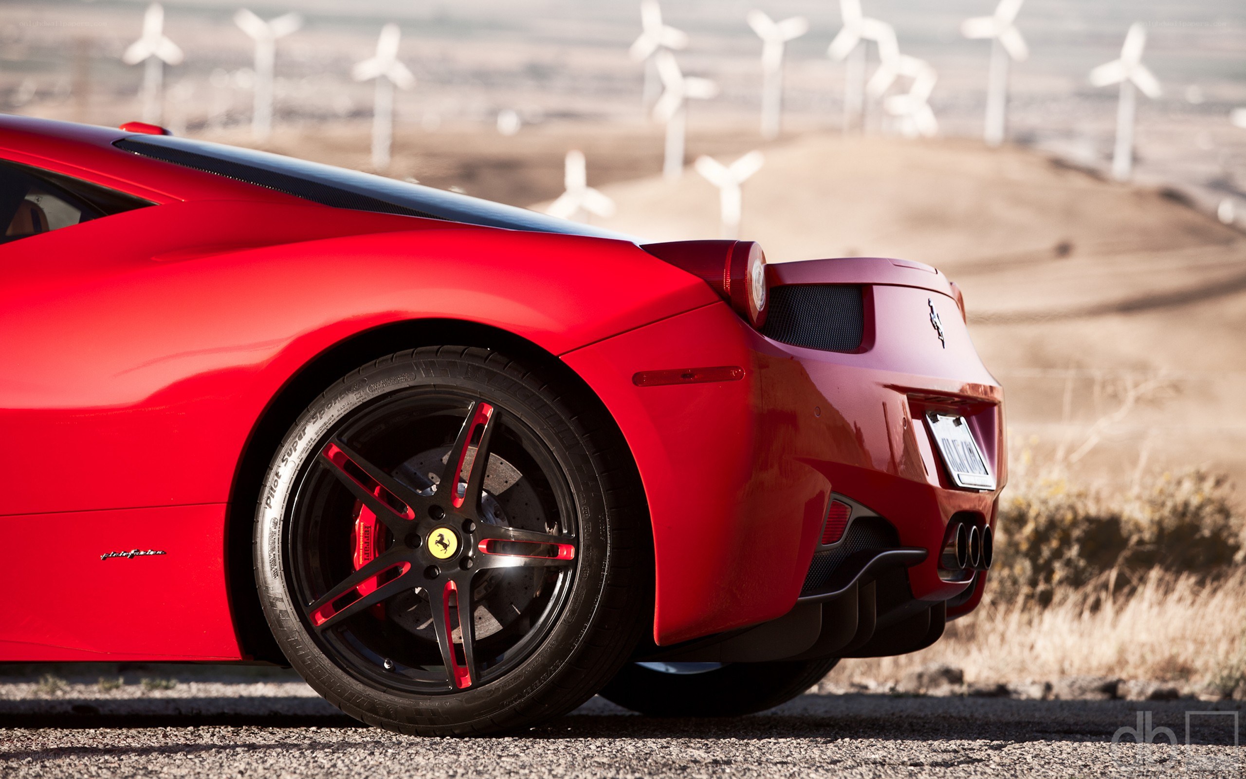 Red Ferrari in wind farm