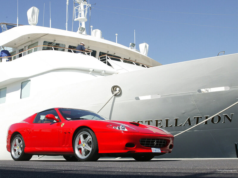 Red Ferrari near yacht