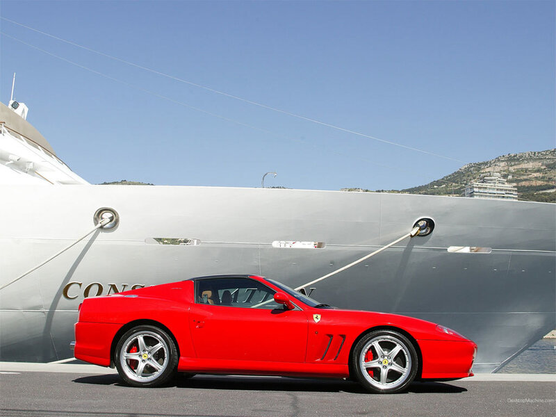 Red Ferrari near yacht