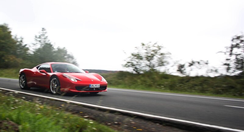 Red Ferrari on a country road