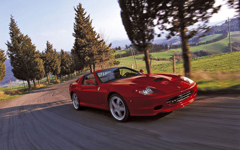Red Ferrari on a country road