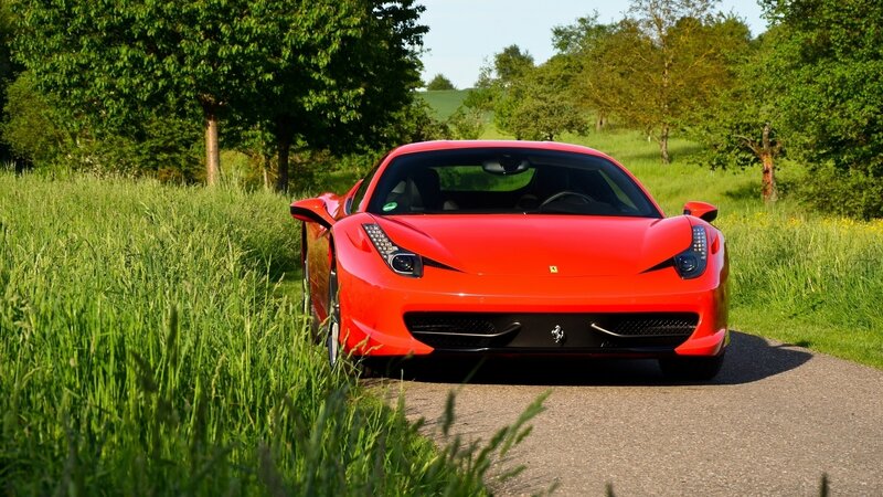 Red Ferrari on a country road