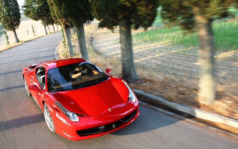 Red Ferrari on a country road