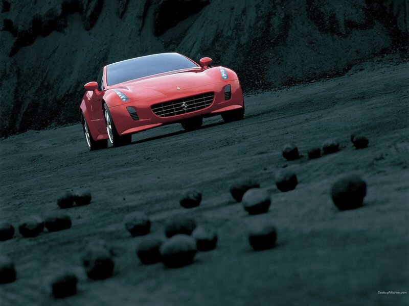Red Ferrari on a dark road