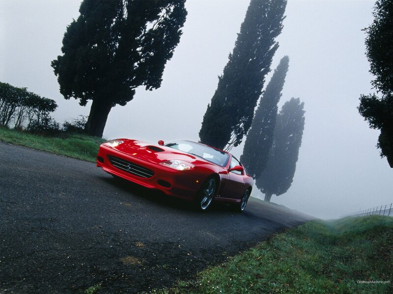 Red Ferrari on a foggy road