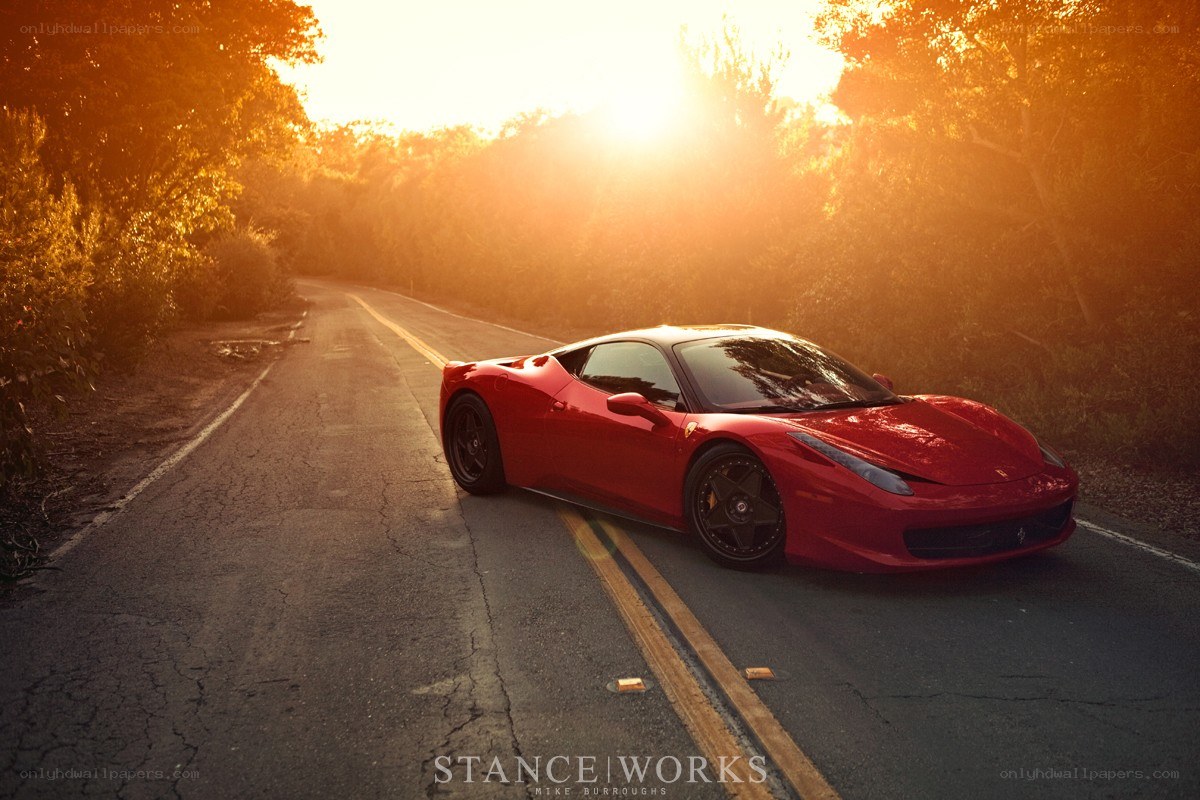 Red Ferrari on a forest road