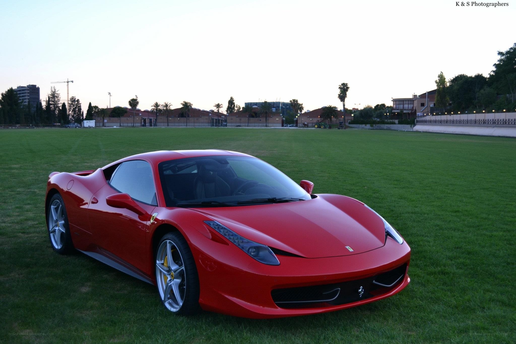 Red Ferrari on a grass field