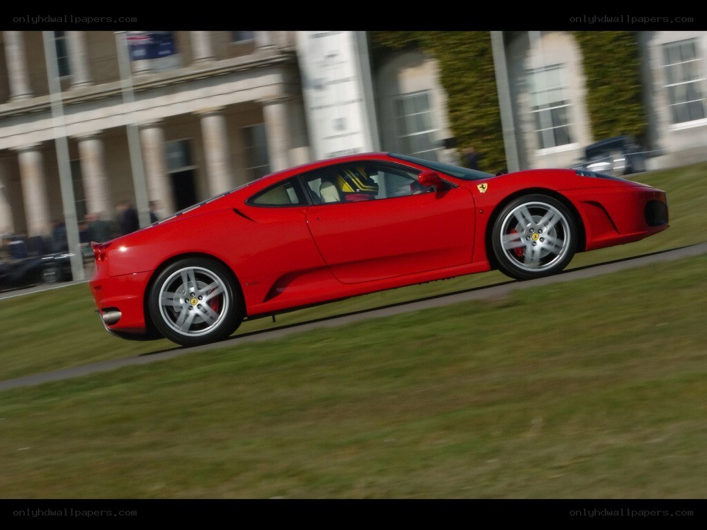 Red Ferrari on a grass track