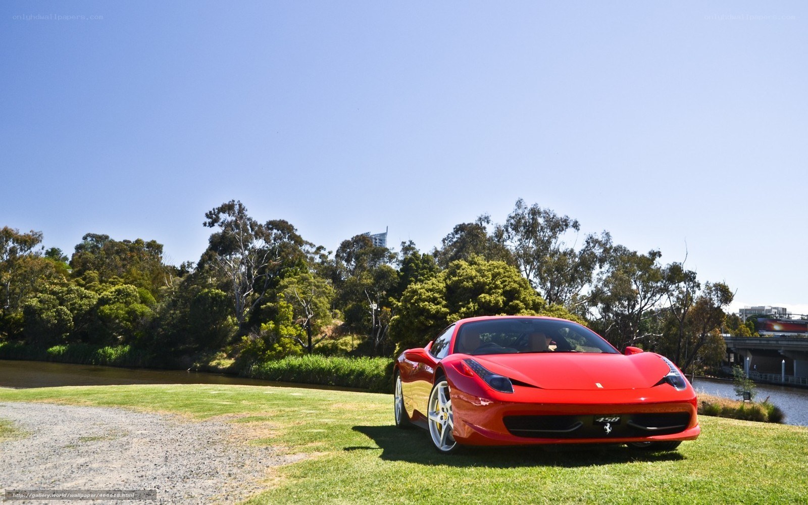 Red Ferrari on a grassy bank