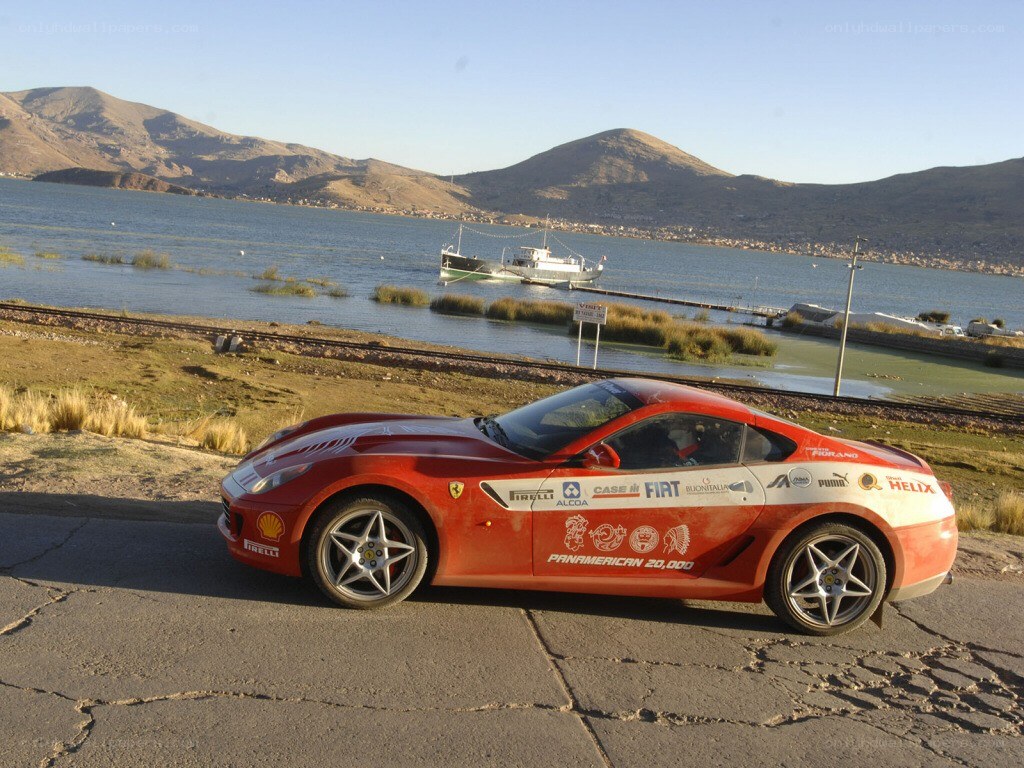 Red Ferrari on a lakeside road