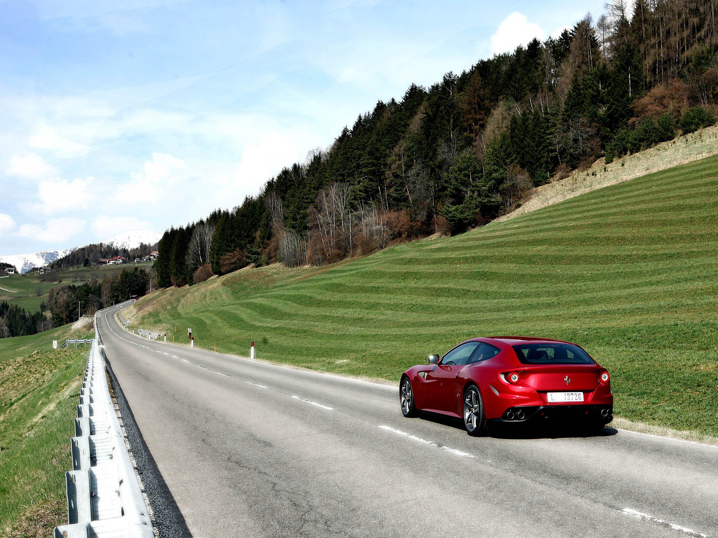 Red Ferrari on a mountain road