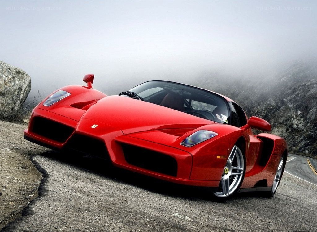 Red Ferrari on a mountain road