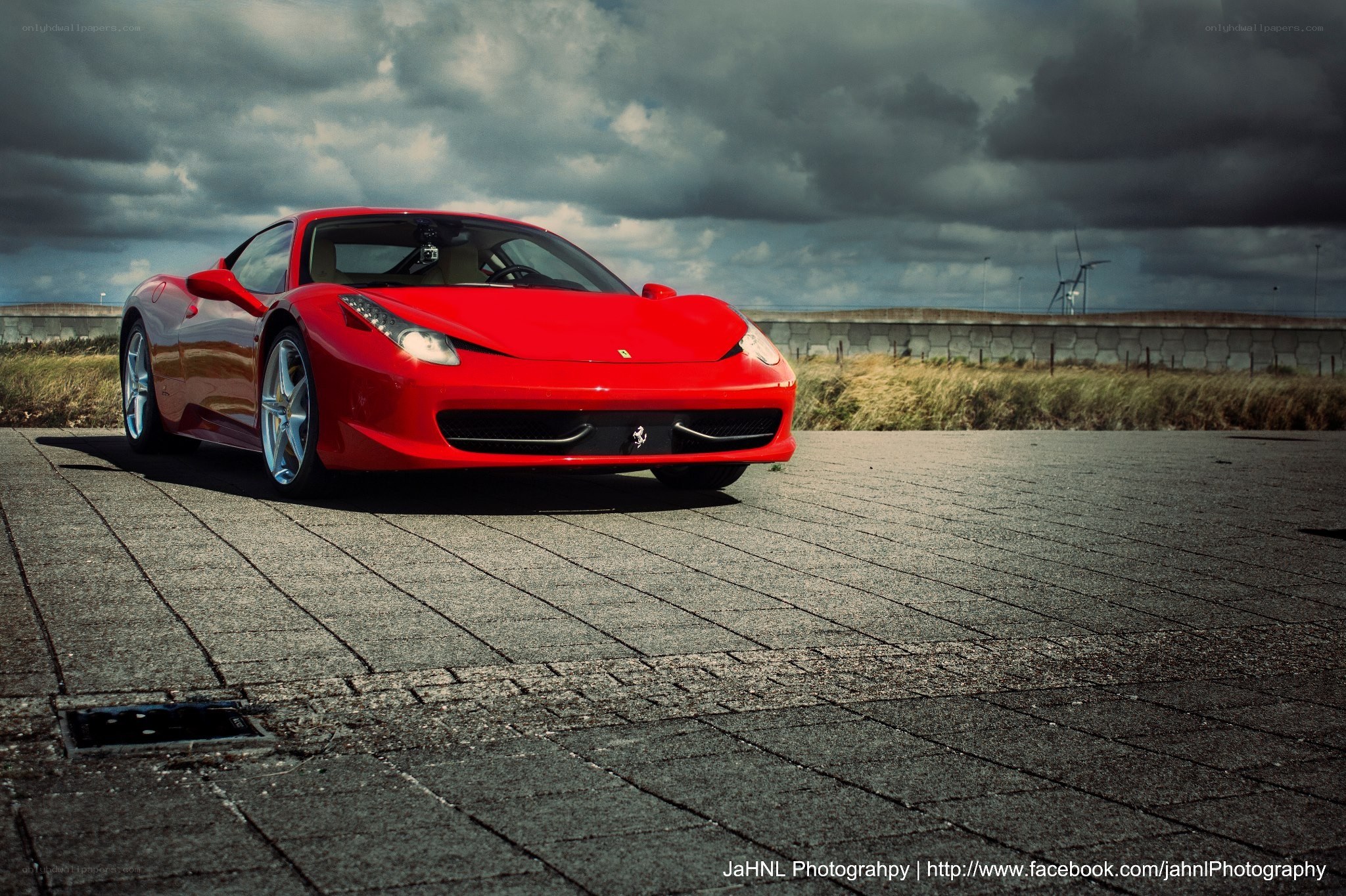 Red Ferrari on a paved lot