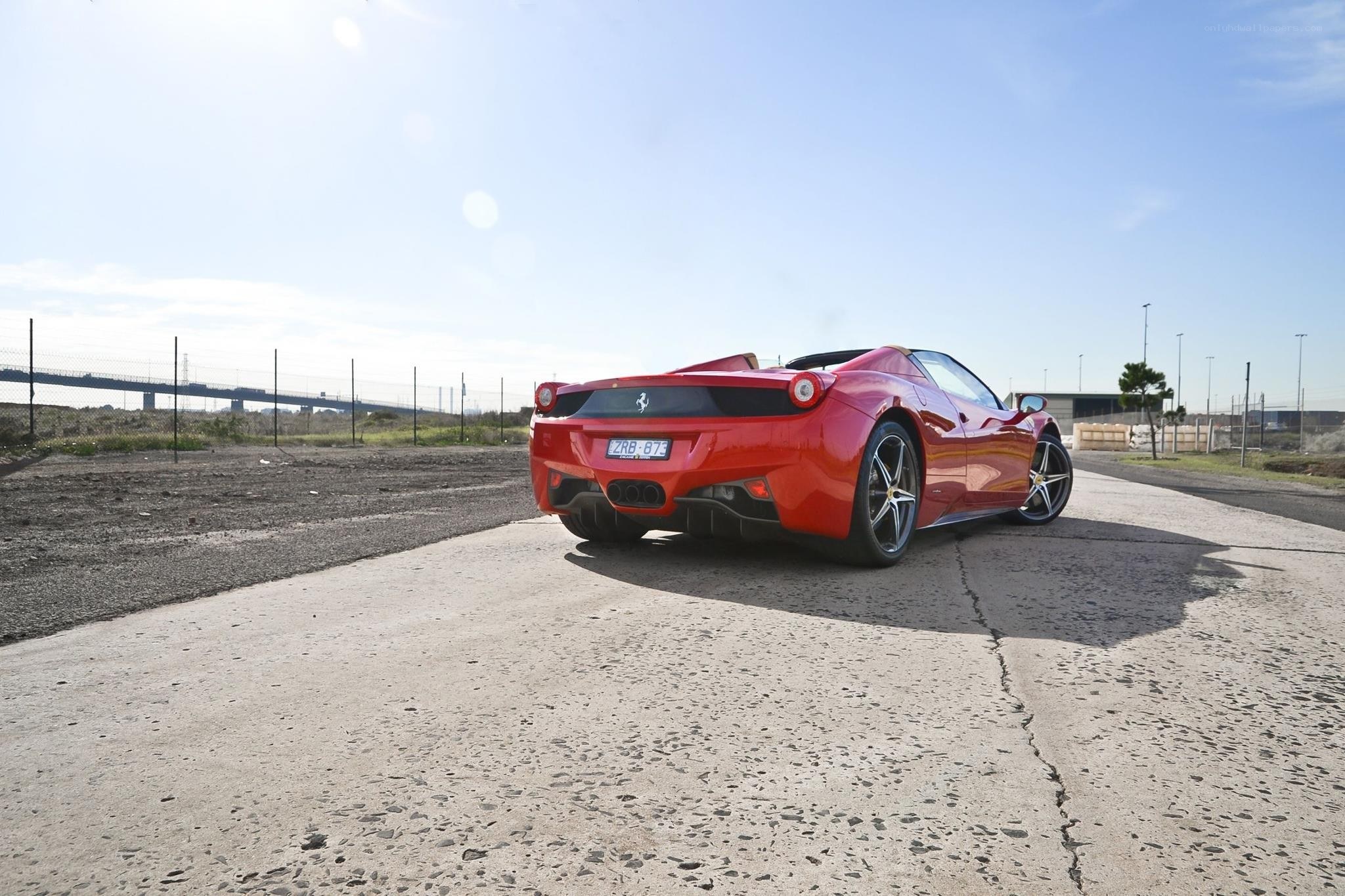 Red Ferrari on a paved road