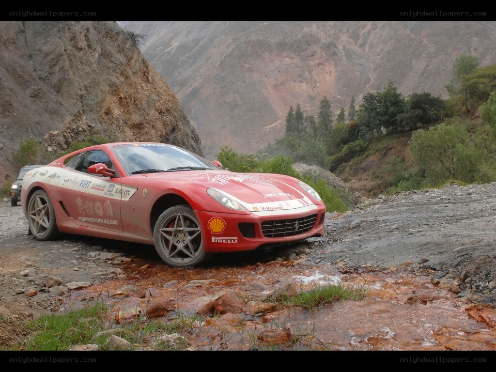 Red Ferrari on a rugged road