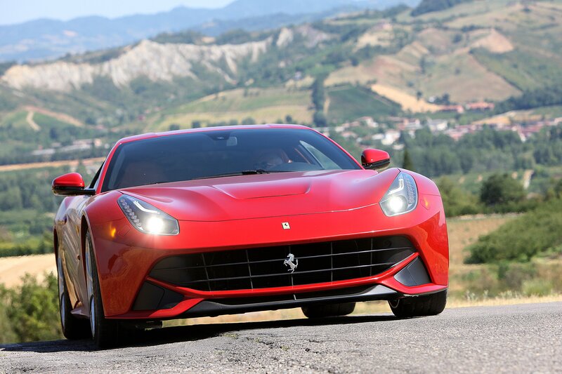 Red Ferrari on a scenic road